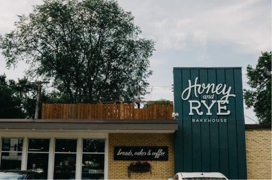 Exterior of Honey and Rye Bakehouse with the large blue Honey and Rye sign