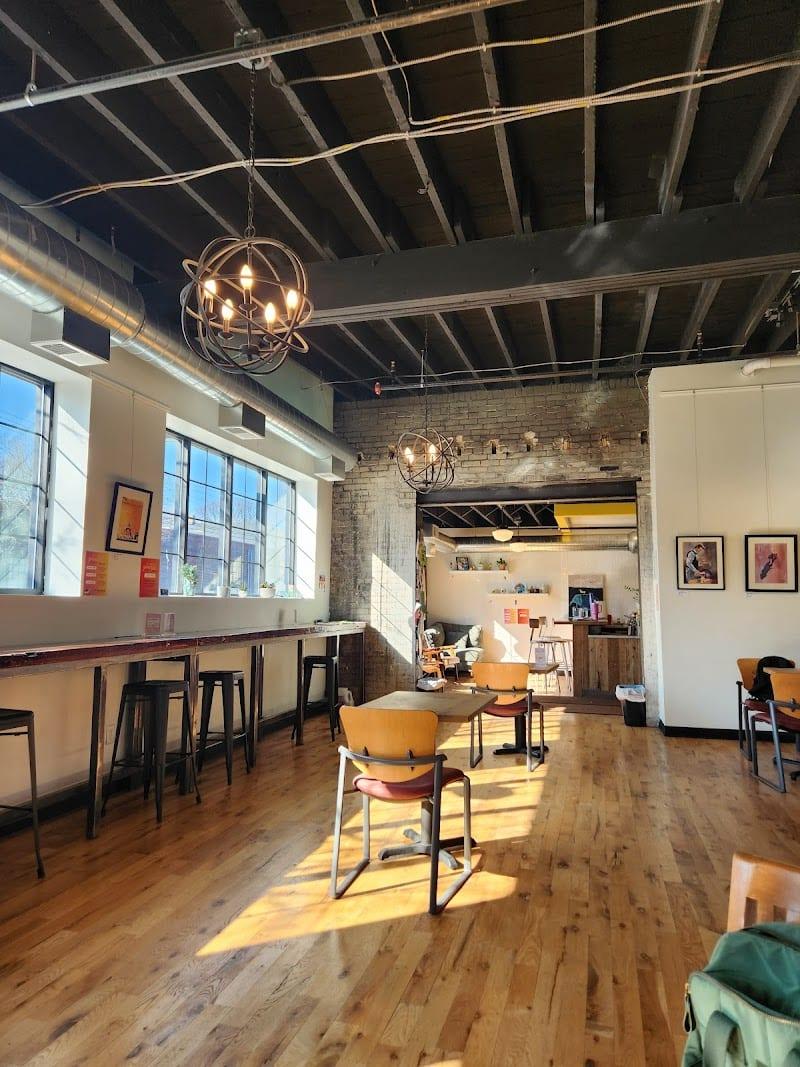 Yellowbird coffee bar interior with warm wood tones and seating